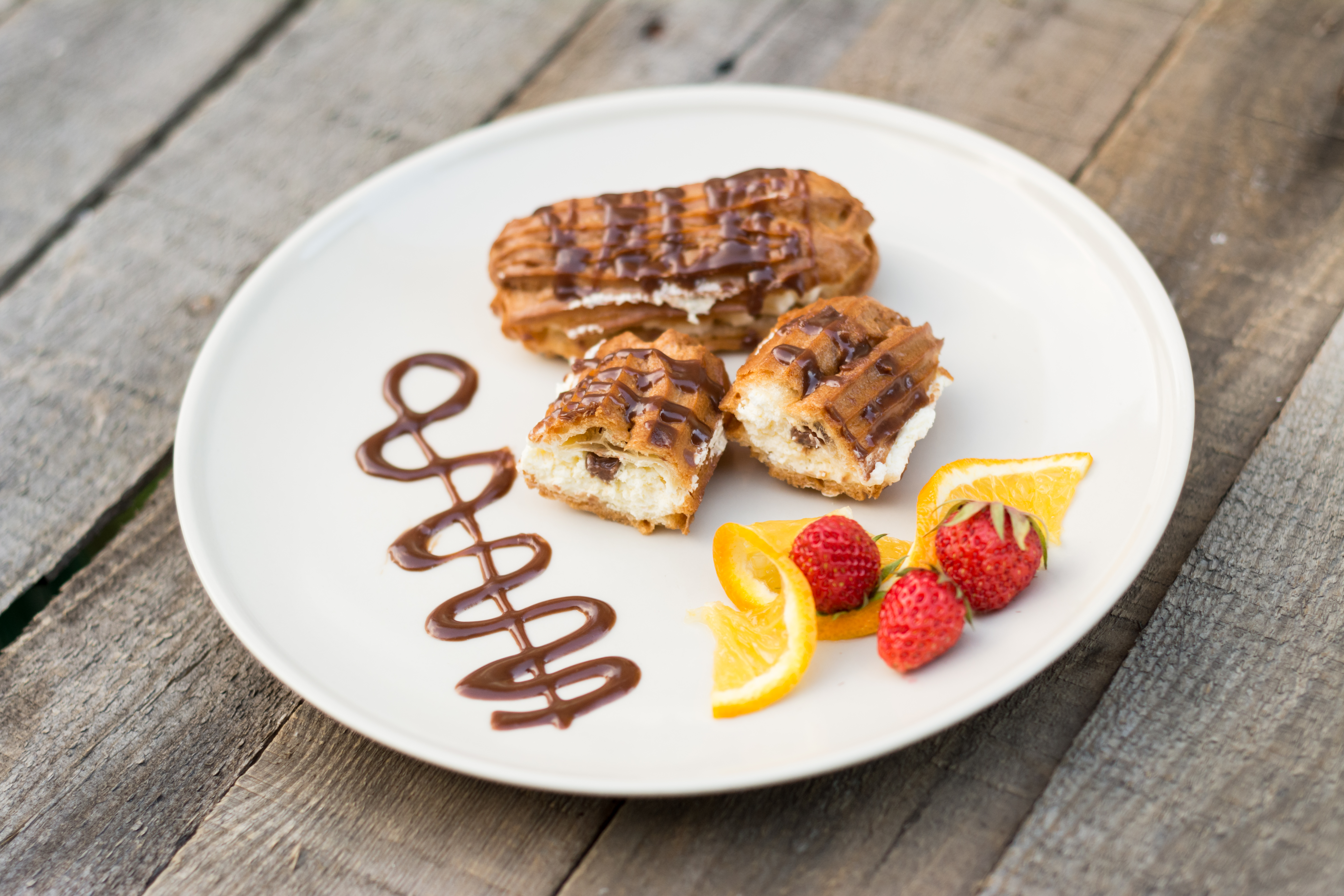 eclairs on a white plate